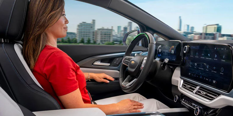 A woman sitting in the drivers seat of a 2025 Chevrolet Equinox EV.