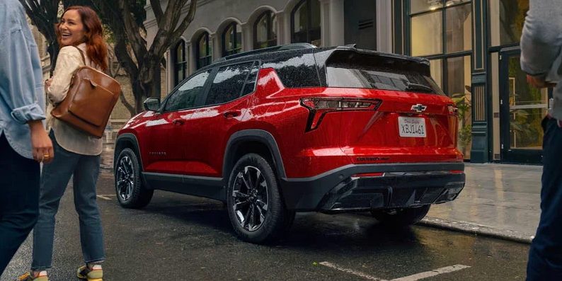 A red 2025 Chevrolet Equinox parked on the side of the road.
