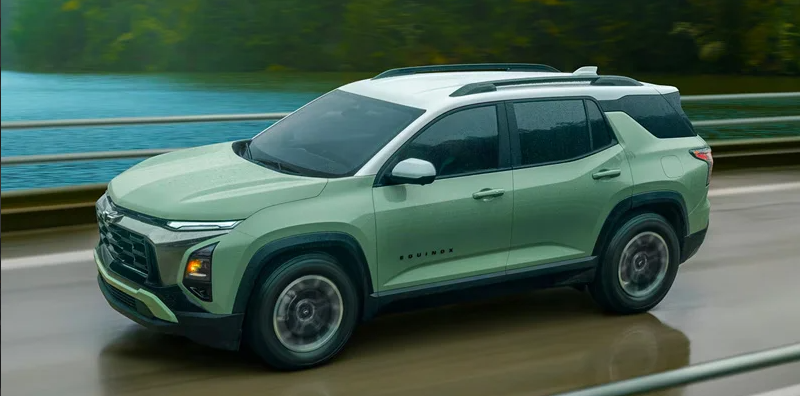 A green 2026 Chevrolet Equinox driving down the road.