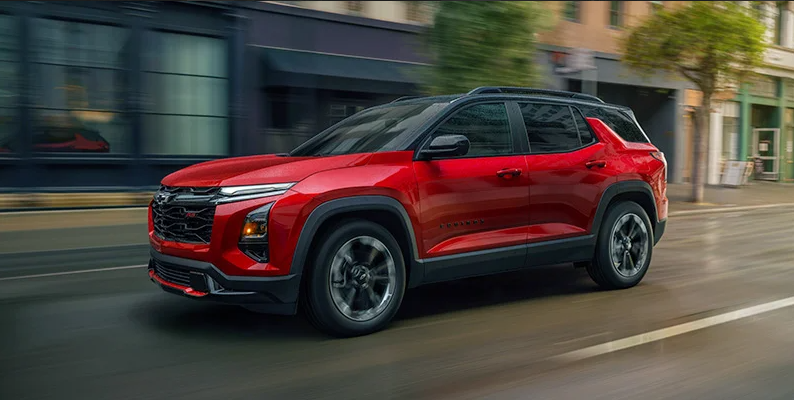 A red 2026 Chevrolet Equinox driving down the road.